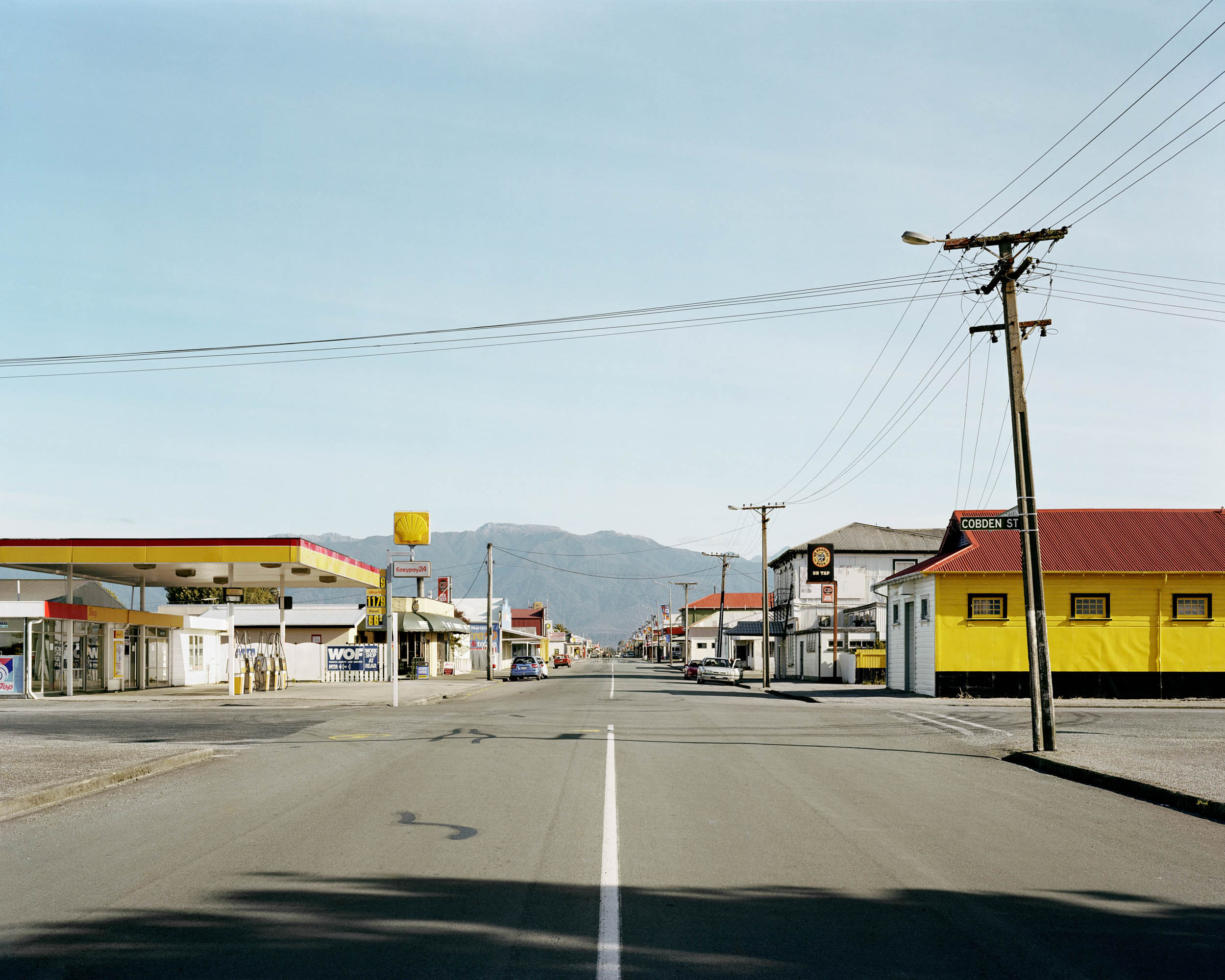 Crossroads of Palmerston and Cobden Streets in Westport, New Zealand. A photograph from Derek Henderson's The Terrible Boredom of Paradise series.